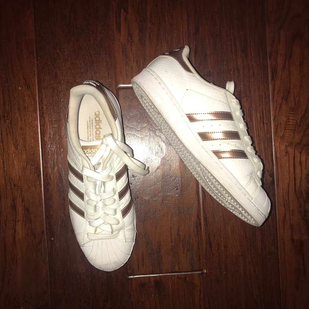 Gold and white adidas superstars